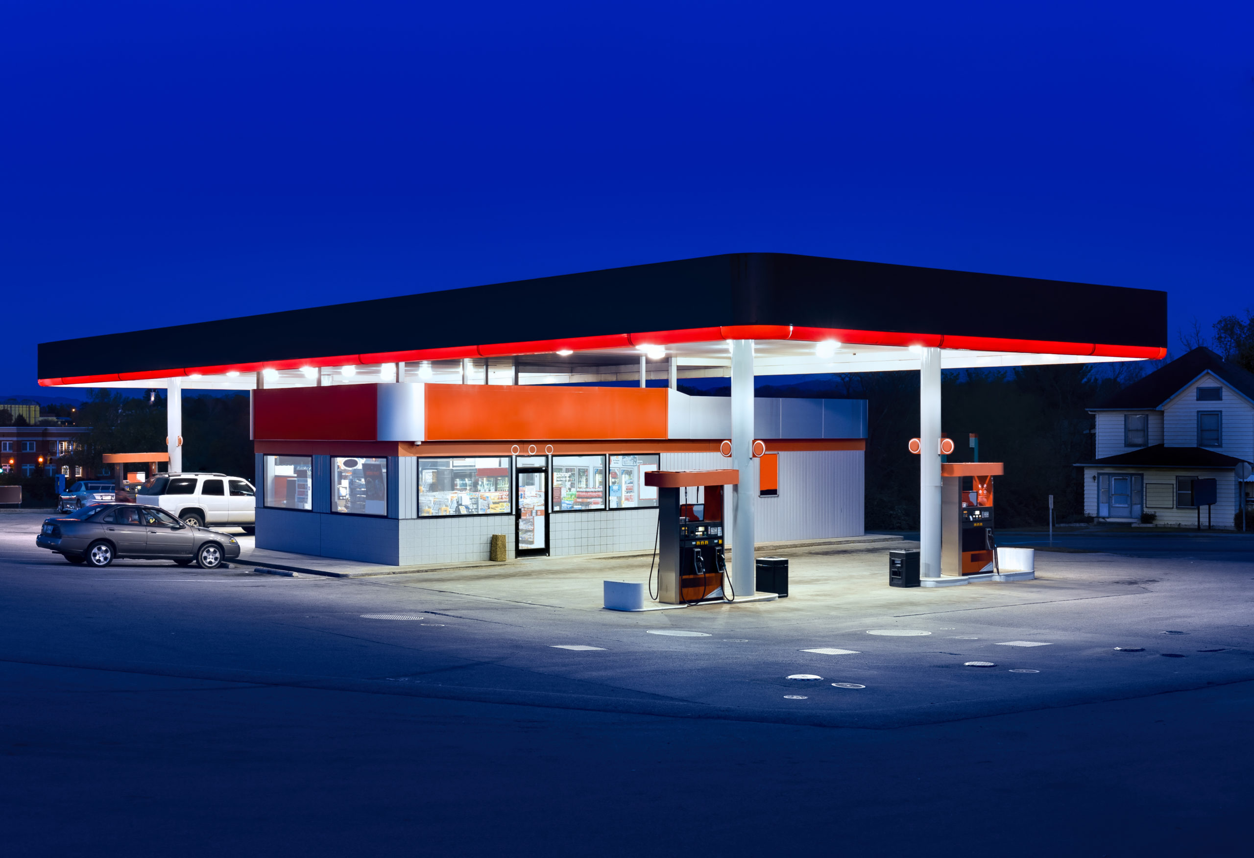 Generic gasoline station and convenience store at dusk.