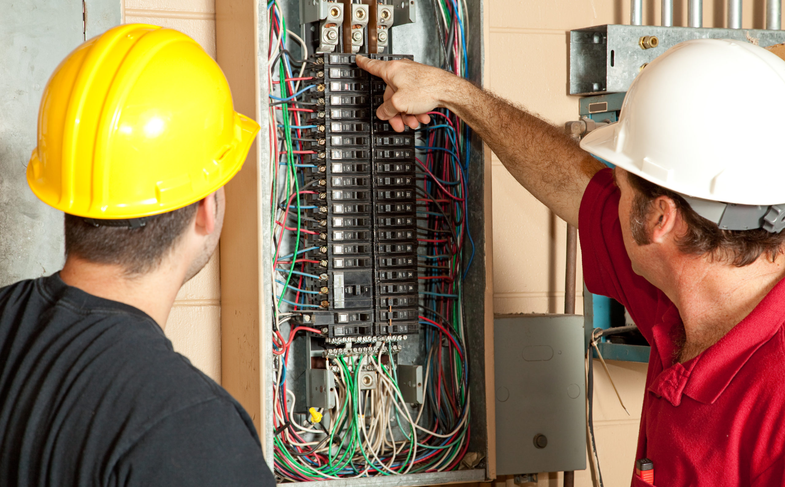 Electricians change a home breaker