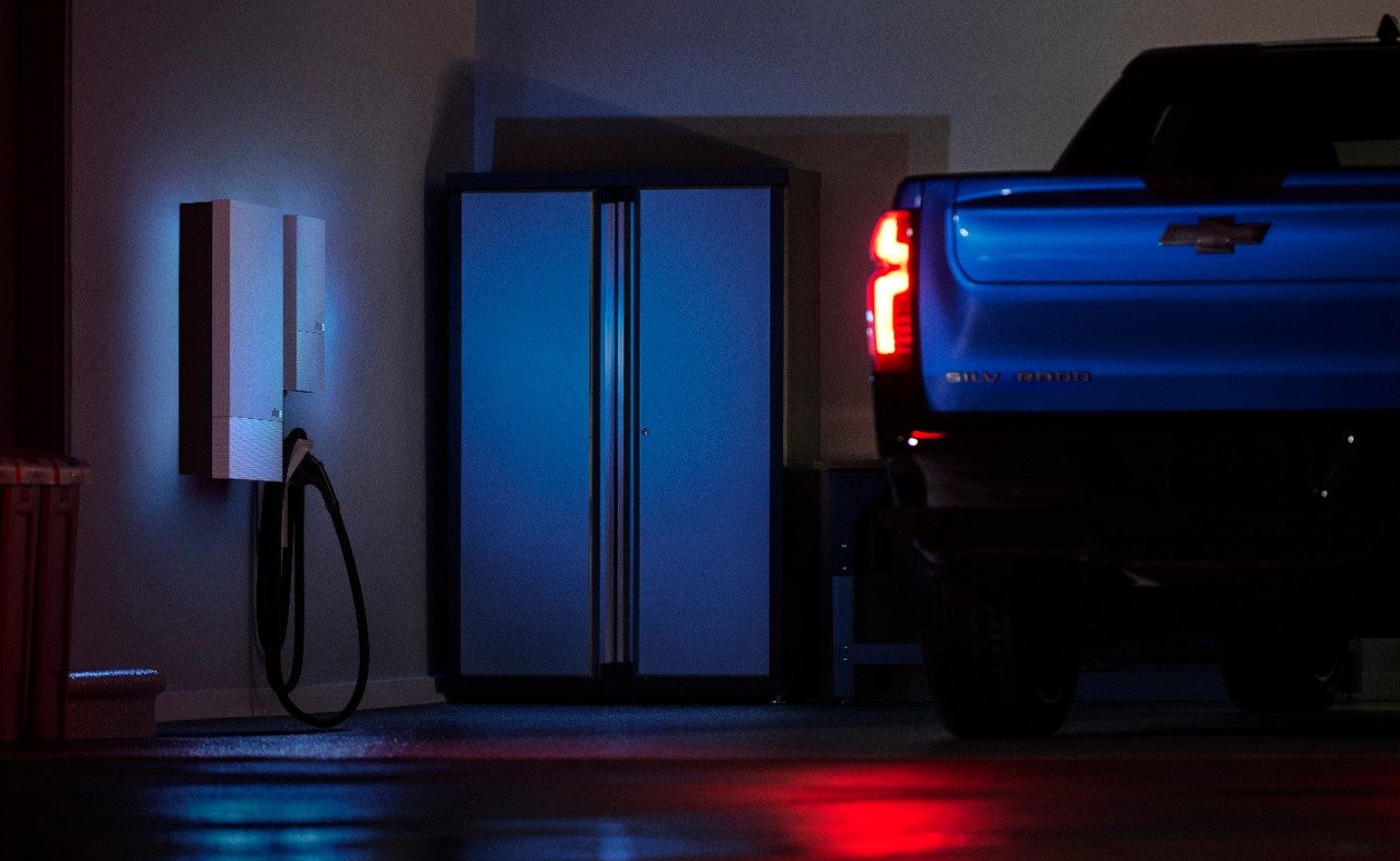 Rendering of a 2024 Chevrolet Silverado RST in a residential home garage equipped with an Ultium Home charger.